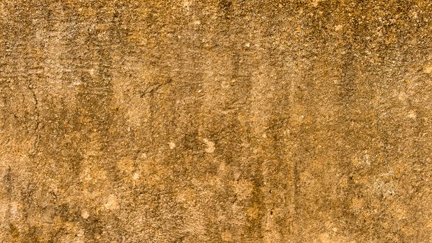Close up Sand Wall Texture Pattern Beach Background design element. Sandy effects on sandstone plaster pillar with minor cracks and uneven patches highlighting Natural Yellow color shade. Copy Space