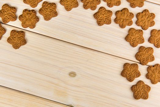 ?hristmas homemade gingerbread cookies on wooden background with empty copy space for your text.