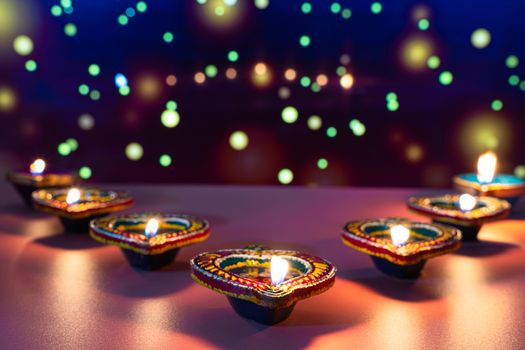 Indian festival Diwali, Diya oil lamps lit on colorful rangoli. Hindu traditional. Happy Deepavali. Copy space for text.