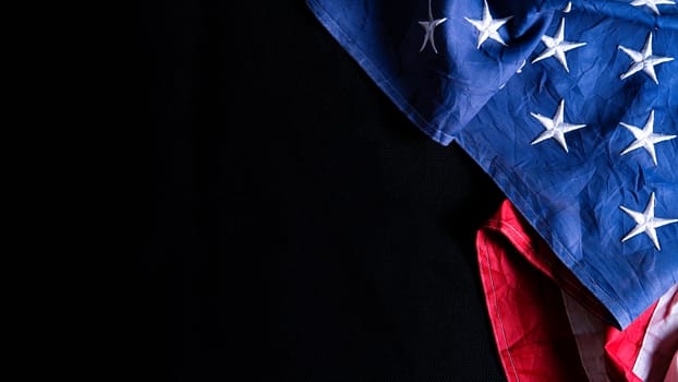 US American flag against black background. For Memorial, Presidents, Veterans, Labor, Independence or 4th of July celebration day. Top view, copy space for text.