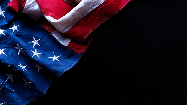 US American flag against black background. For Memorial, Presidents, Veterans, Labor, Independence or 4th of July celebration day. Top view, copy space for text.