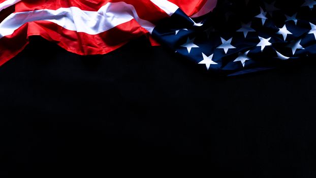 US American flag against black background. For Memorial, Presidents, Veterans, Labor, Independence or 4th of July celebration day. Top view, copy space for text.