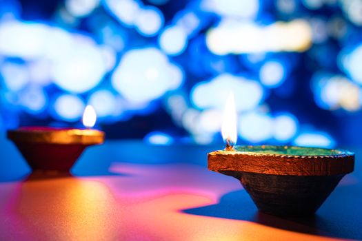 Indian festival Diwali, Diya oil lamps lit on colorful rangoli. Hindu traditional. Happy Deepavali. Copy space for text.