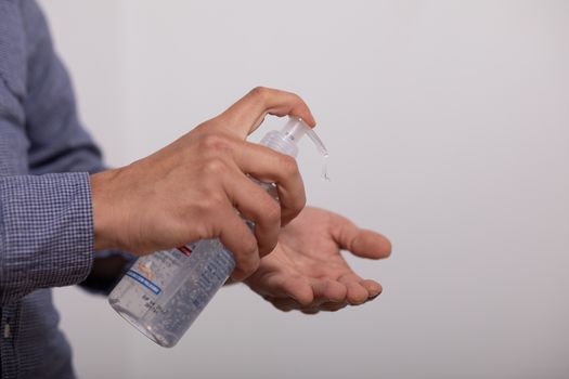 Hand of man that applying alcohol gel to make cleaning and clear germ, bacteria, Health care concept