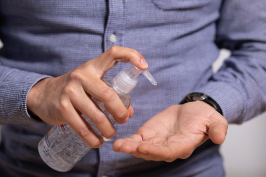 Hand of man that applying alcohol gel to make cleaning and clear germ, bacteria, Health care concept