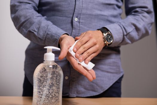 Hand of man that applying alcohol gel with wet wipes to make cleaning and clear germ, bacteria. Health care concept