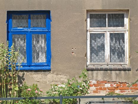 House with a blue and a white window.