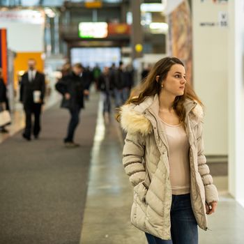 Portrait of a woman walking while attending an event at the convention trade center in Brno. BVV Brno Exhibition center. Czech Republic