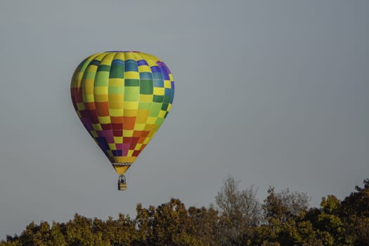 Hot air balloon taking off over the woods