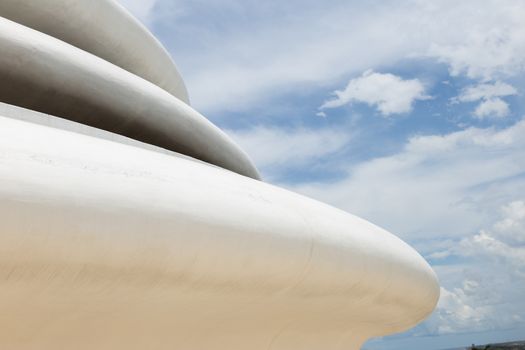 Unawatuna, Sri Lanka 15.4.2018 Japanese Peace Pagoda white temple detail of curved structure against blue sky with clouds. High quality photo