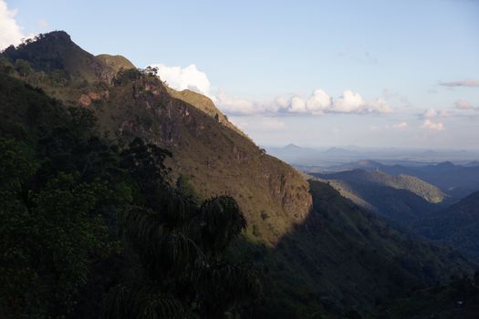 Ella Sri Lanka mountain gap landscape views across the wide valley to mountains in the distance against blue skies with clouds Adams Peak. High quality photo