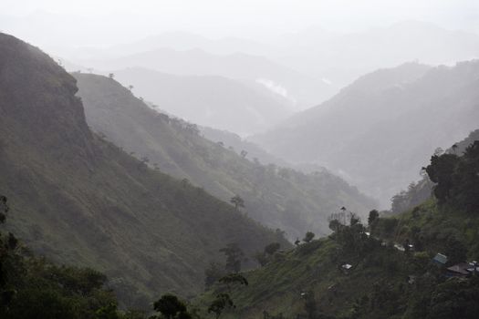 Ella Sri Lanka mountain gap landscape views across the wide valley to mountains in the distance misty early morning Adams Peak. High quality photo