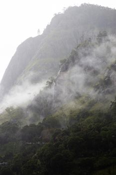 Ella Sri Lanka mountain gap landscape views across the wide valley to mountains in the distance misty early morning Adams Peak. High quality photo