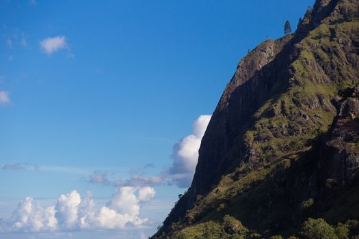 Ella Sri Lanka mountain gap landscape views across the wide valley to mountains in the distance against blue skies with clouds Adams Peak. High quality photo