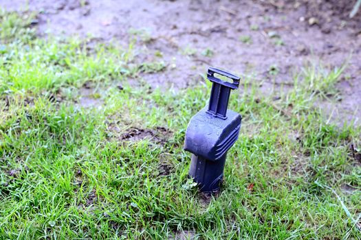 A laid trap into an earth ground for catching a rodent, mouse or water vole in the garden.