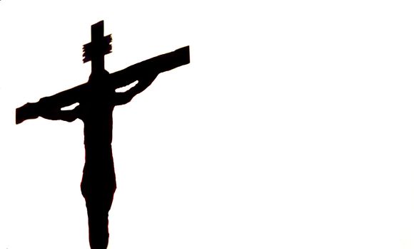 Silhouette of the crucified Jesus on a white background, copyspace. Easter religous symbol.