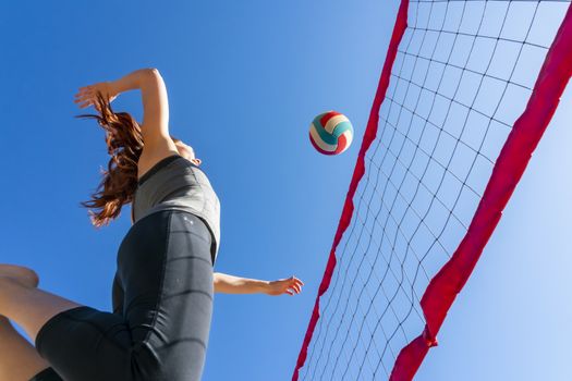 A redhead fitness model preparing to play volleyball
