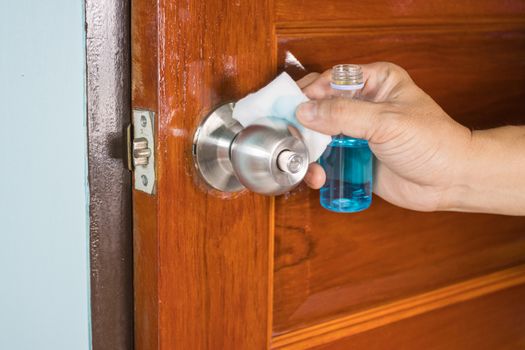 Prevention cleaning Door handles by Disinfectant solution for killing corona virus on touching surfaces, concept coronavirus COVID19
