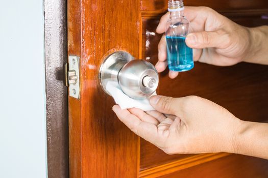 Prevention cleaning Door handles by Disinfectant solution for killing corona virus on touching surfaces, concept coronavirus COVID19
