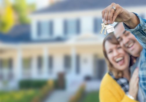 Mixed Race Couple in Front of House with Keys.