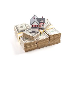 Small House on Stacks of Hundred Dollar Bills Isolated on a White Background.
