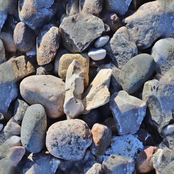 Photo realistic seamless texture pattern of pebbles and stones at a baltic sea beach