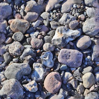 Photo realistic seamless texture pattern of pebbles and stones at a baltic sea beach