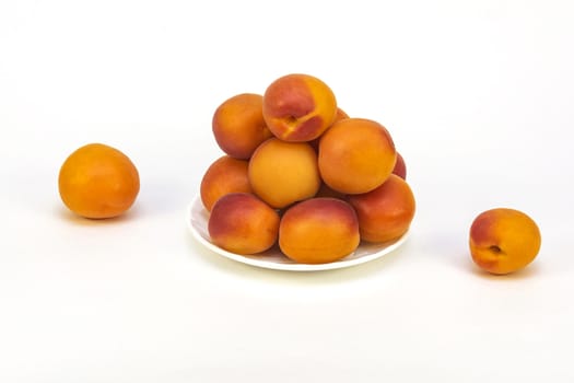 On a light background lie fresh ripe apricots