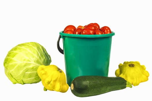 Bucket with tomatoes, cabbage, zucchini and squash on a white background