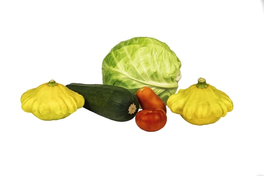 Cabbage, zucchini, squash and tomato on white background