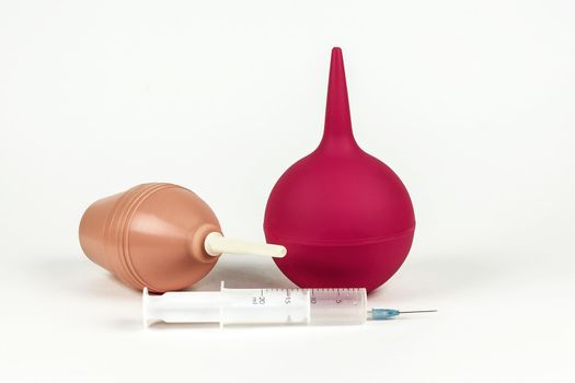 Two medical syringes and a medical syringe with a needle