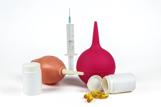 Medical syringe with needle, two medical syringes and pills on light background
