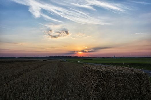 Evening sunset in the field after harvesting