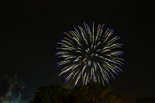 On the night sky, a bright firework ball flashed