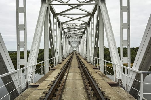 Railroad tracks and sleepers railway bridge and railway bridge across the river