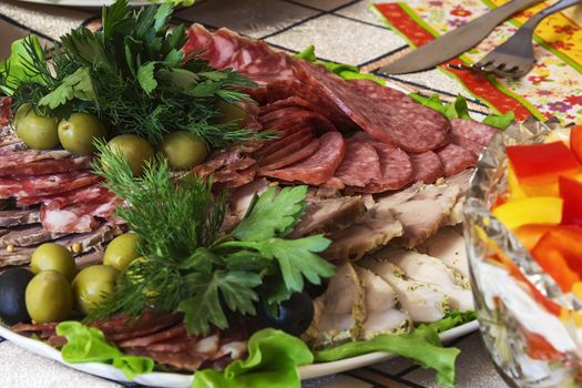 Meat cut with olives, olives, dill and parsley