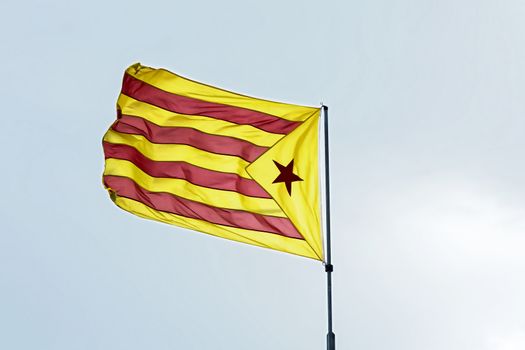 Yellow-red flag with five-pointed star. Red "astalaza" - the flag of the socialist movement of Catalonia (Spain)