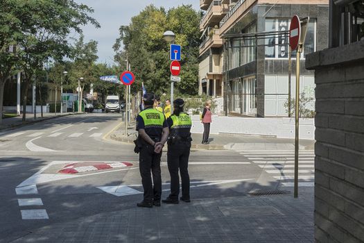 Spain, Blanes - 09/23/2017: Two policemen stand at the crossroads of the city street