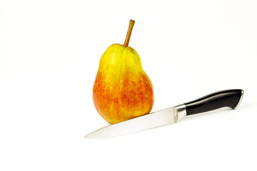 On a white background there is a ripe pear and a knife