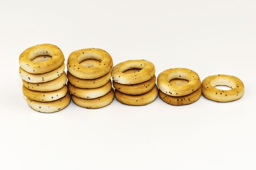Dryings with poppy seeds on a white background are spread out with a ladder