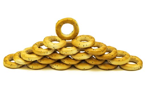 On a white background poppy bagels are stacked on each other