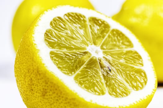 On a white background a cut half of a lemon close-up