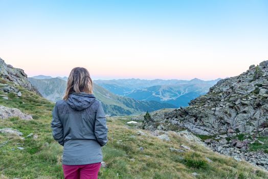 Woman in the Vall de Riu lake from the Estanyo peak in Andorra in summer 2020.