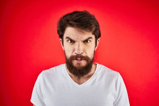 man in t-shirt gesturing with his hands dissatisfaction studio red uniform. High quality photo