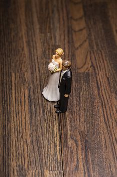 Bride and groom wedding topper against wood background