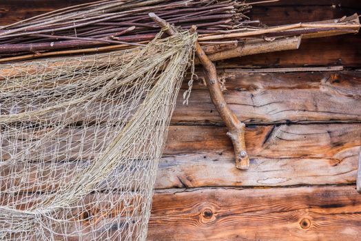 Fishing old network on wooden wall, fishing net texture of fisherman folk, woven with nylon rope.