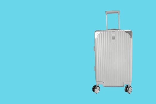 Silver luggage bag with copy space on blue background