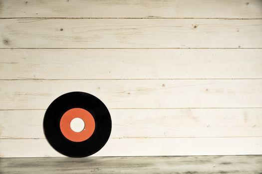 Vinyl record on wooden background,Old vintage vinyl record isolated