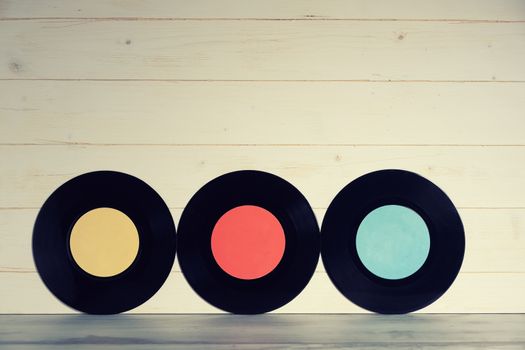 Three Vinyl records on wooden background,Old vintage vinyl records isolated