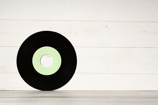 Vinyl record on wooden background,Old vintage vinyl record isolated